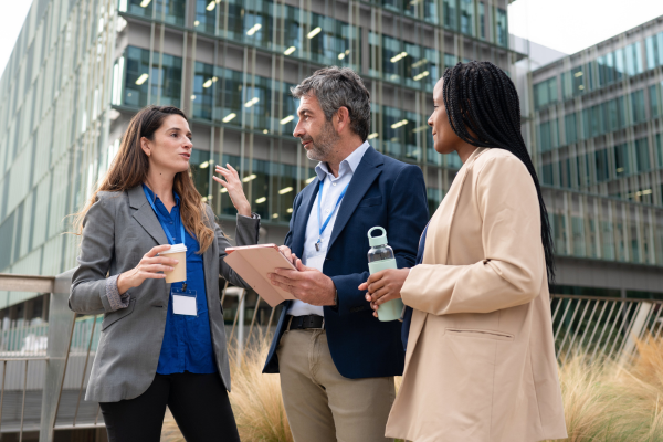 Three registered process servers in suits talking